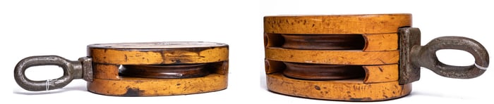 A pair of vintage wood and iron ship's block and tackle pulleys