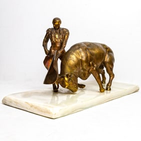 A Continental patinated metal figure of a Matador and bull on alabaster base