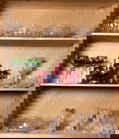 Three shelves of mainly cut glass