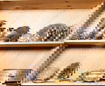 Two shelves of mainly metal decorations