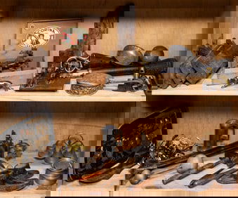 Two shelves of mainly metal decorations and architectural elements