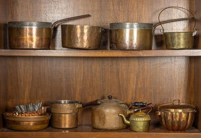 A group of copper pots and molds