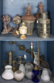 Two shelves of lanterns, wall sconces and glass shades