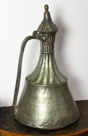 A tall Turkish copper water jug