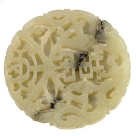 A Chinese white jade circular pendant