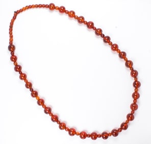 A Chinese amber bead necklace