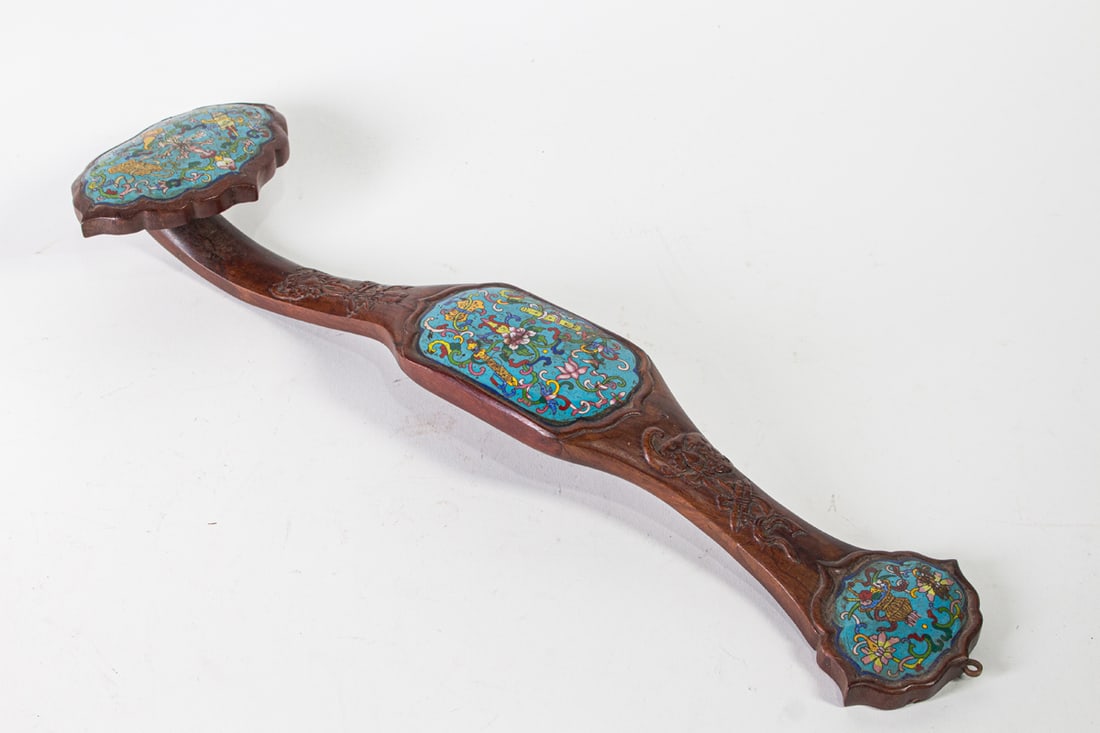A Chinese hardwood ruyi scepter inlaid with cloisonne tops: A Chinese hardwood ruyi scepter inlaid with cloisonne tops. Republic period, 20.5" across.