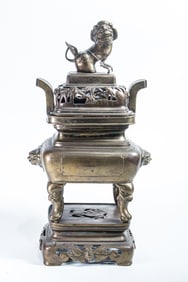 A Chinese bronze footed censer with cover and stand