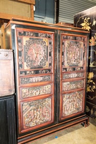 A Chinese hardwood black and red lacquered cabinet