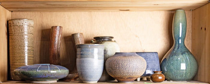 A shelf of Japanese glazed ceramic objects