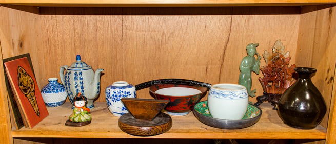Five shelves of Chinese and Japanese decorative objects