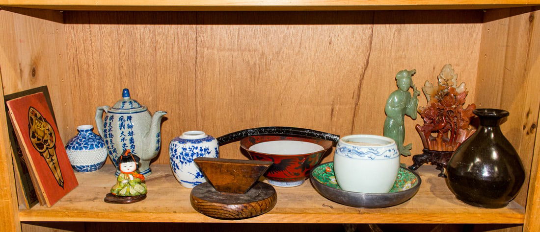 Five shelves of Chinese and Japanese decorative objects: Five shelves of Chinese and Japanese decorative objects. 19th century and later, 13.25" tallest.