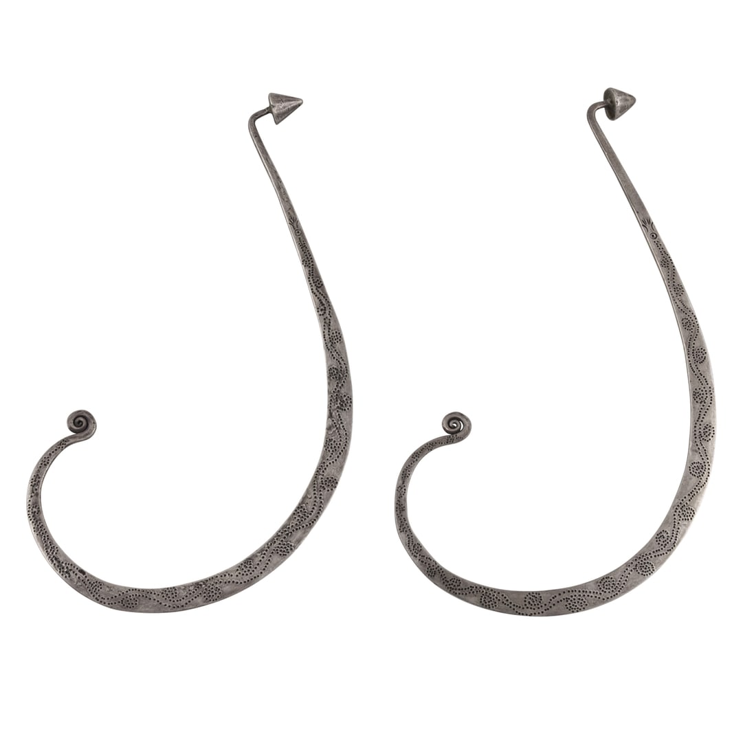 A pair of Hmong silver ear ornaments: A pair of Hmong silver ear ornaments. 6.75" and 6.875" wide, 65 grams in total. Provenance: Naomi Lindstrom collection.