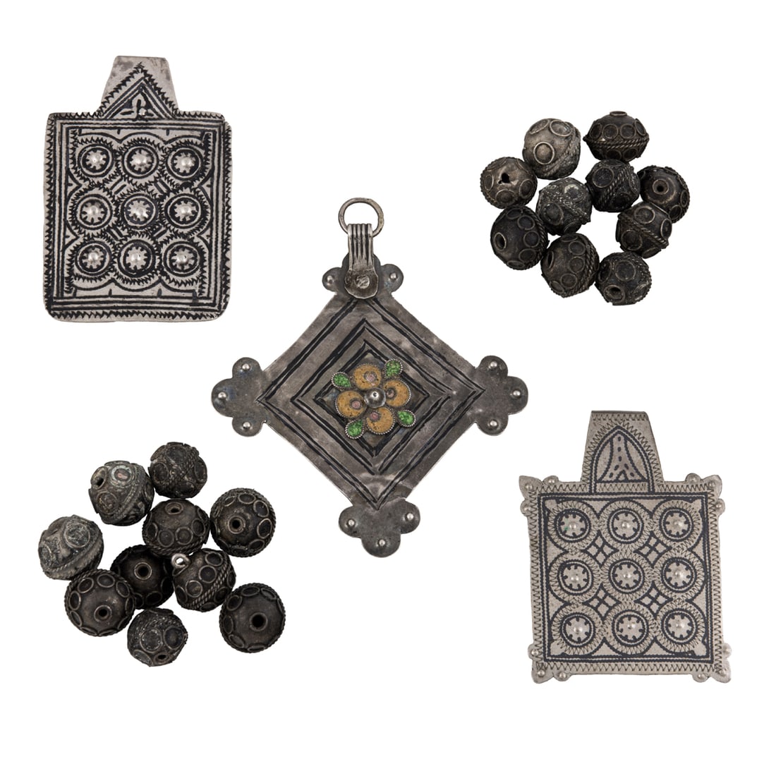 A group of Moroccan silver beads and pendants: A group of Moroccan silver beads and pendants. From 0.625" to 3.75" across, 98 grams. Provenance: Naomi Lindstrom collection.