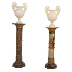 A pair of Italian carved alabaster urns on associated alabaster pedestals
