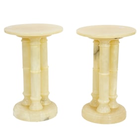 A pair of Classical style alabaster pedestal side tables