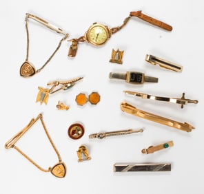 A group of gold tone mens accessories