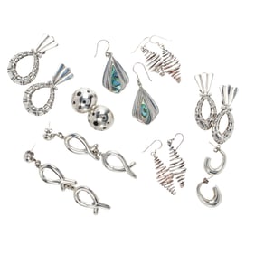 A group of sterling silver earrings
