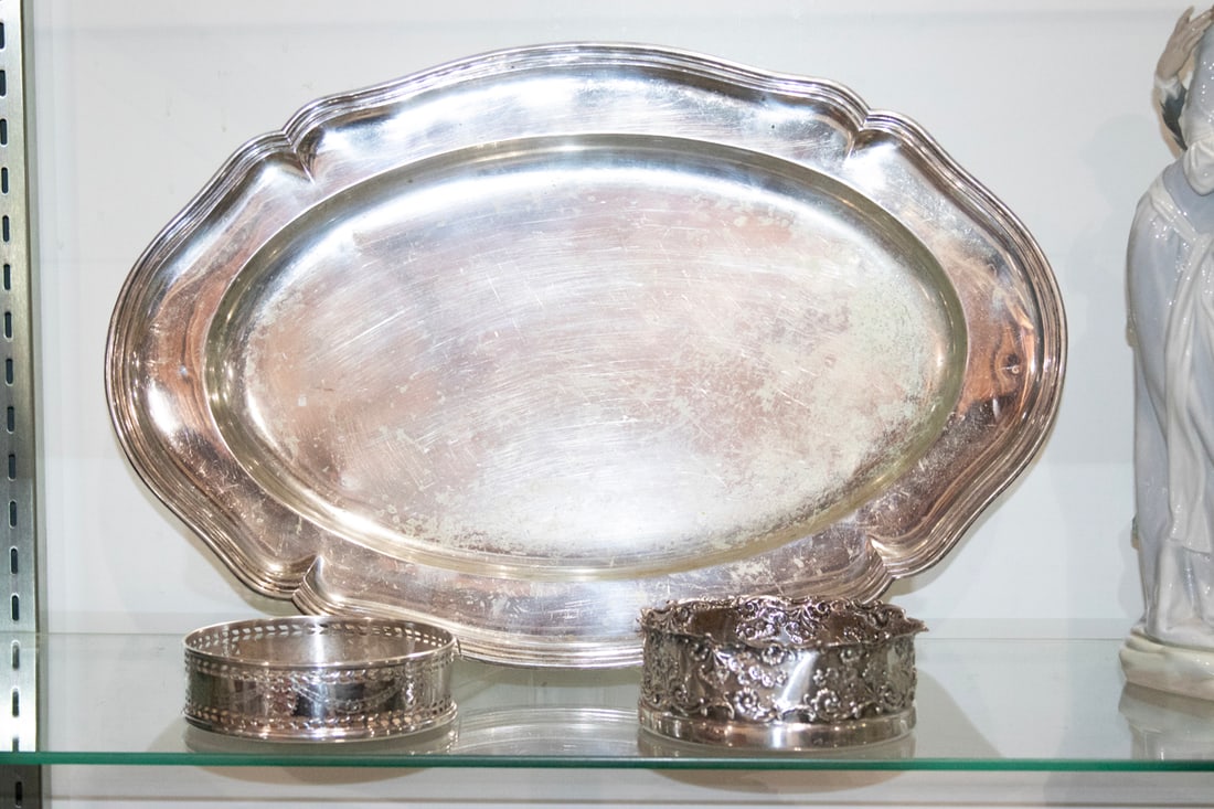 A German 800-silver tray accompanied by two wine coasters: A German 800-silver tray accompanied by two wine coasters, the tray with serpentine outline, 18.75" l; with (1) sterling repousse wine coaster, 5.25" dia; (1) silverplate wine coaster. 28.71 troy oz.
