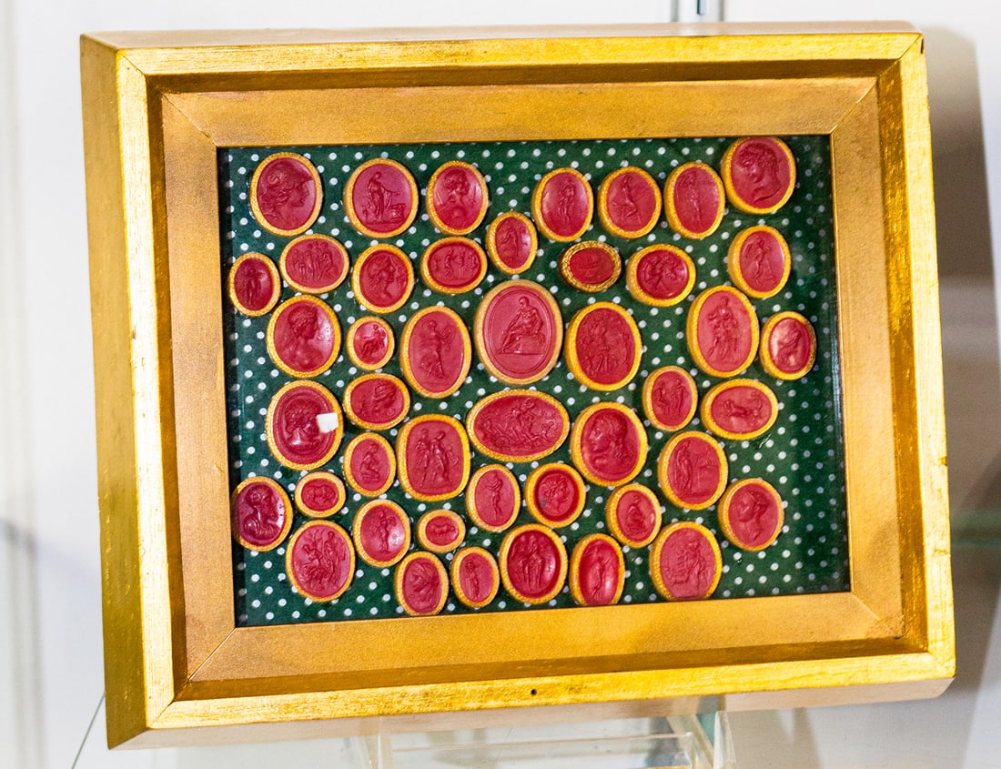 A framed collection of Grand Tour red wax intaglios: A framed collection of Grand Tour red wax intaglios, approximately 46 impressions, greatest intaglio 1"h; framed 8"h x 9.75"w