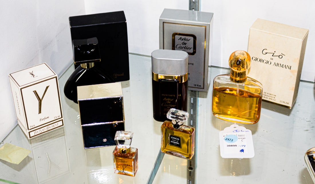 A collection of five perfumes including Chanel No. 5: A collection of five perfumes, comprising (1) unopened 14 ml Chanel No. 5; (1) YSL. 7.5 ml;; (1) Louis Feraud, Fantasque, 1.7 fl oz; (1) Cartier eau de toilette for men, 1.6 fl. oz; (1) Giorgio Armani