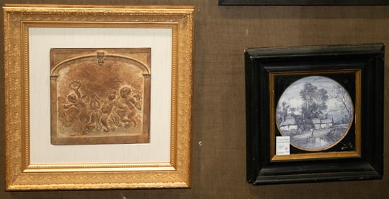 Two framed terracotta tiles, figural and a landscape