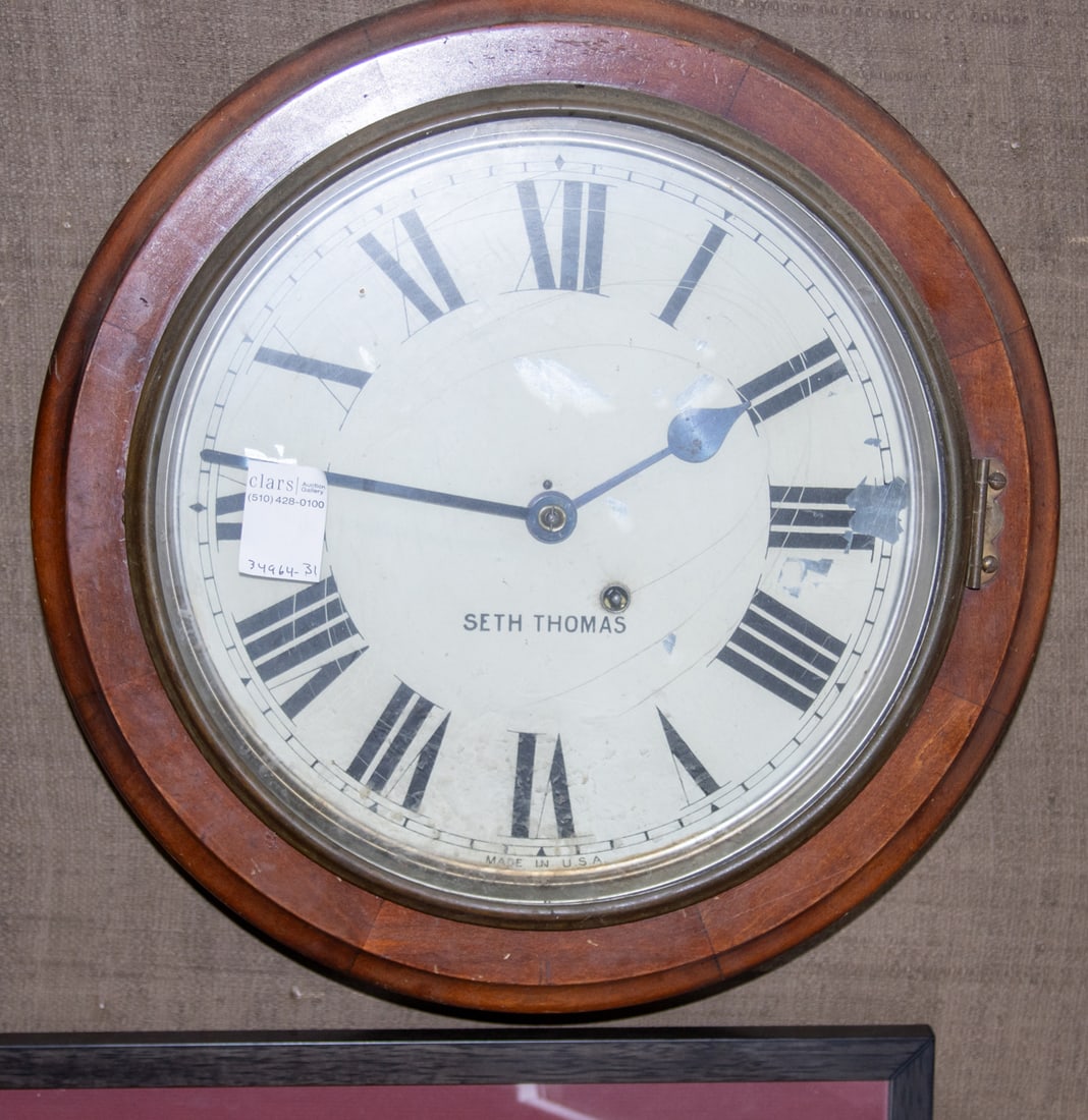 A Seth Thomas round wall clock: A Seth Thomas round wall clock, early 20th century, case indistinctly stamped '1913C' and papered directions to reverse, 16"dia.