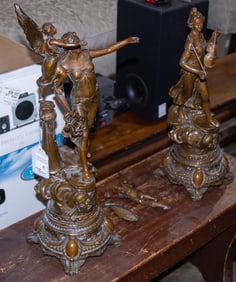 A pair of patinated metal allegorical figures of music