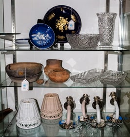 An assembled group of ceramics, glass and wall sconces