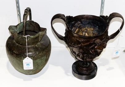A primitive copper double spout water jug with iron handle