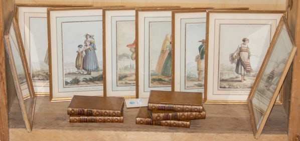 An assembled group of books and framed prints