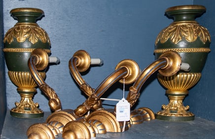 A pair of Baroque style parcel giltwood urns and a pair of two-light wall sconces