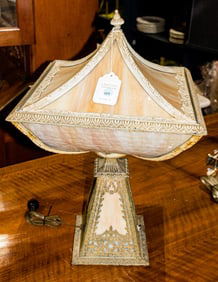 An American patinated metal and slag glass table lamp with two part shade