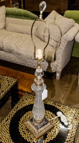 A pair of porcelain figural boudoir lamps and a cut glass table lamp