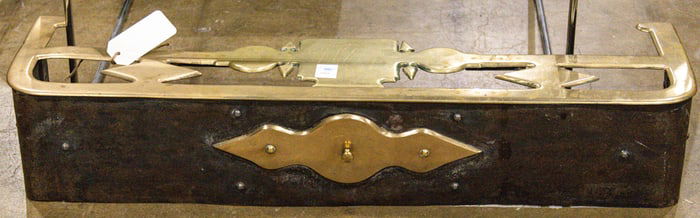 A brass and iron fire fender