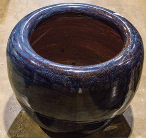 A blue glazed ceramic garden planter