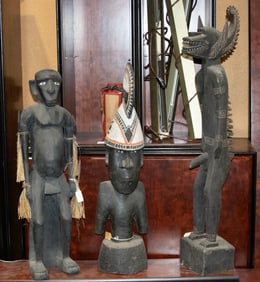 Three carved and painted tribal figures