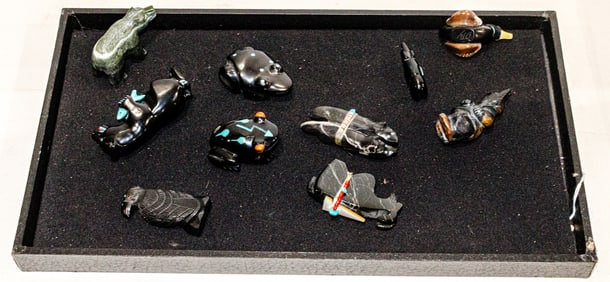 A collection of ten carved stone and wood fetishes