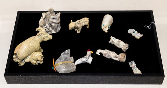 A collection of ten carved stone and other fetishes