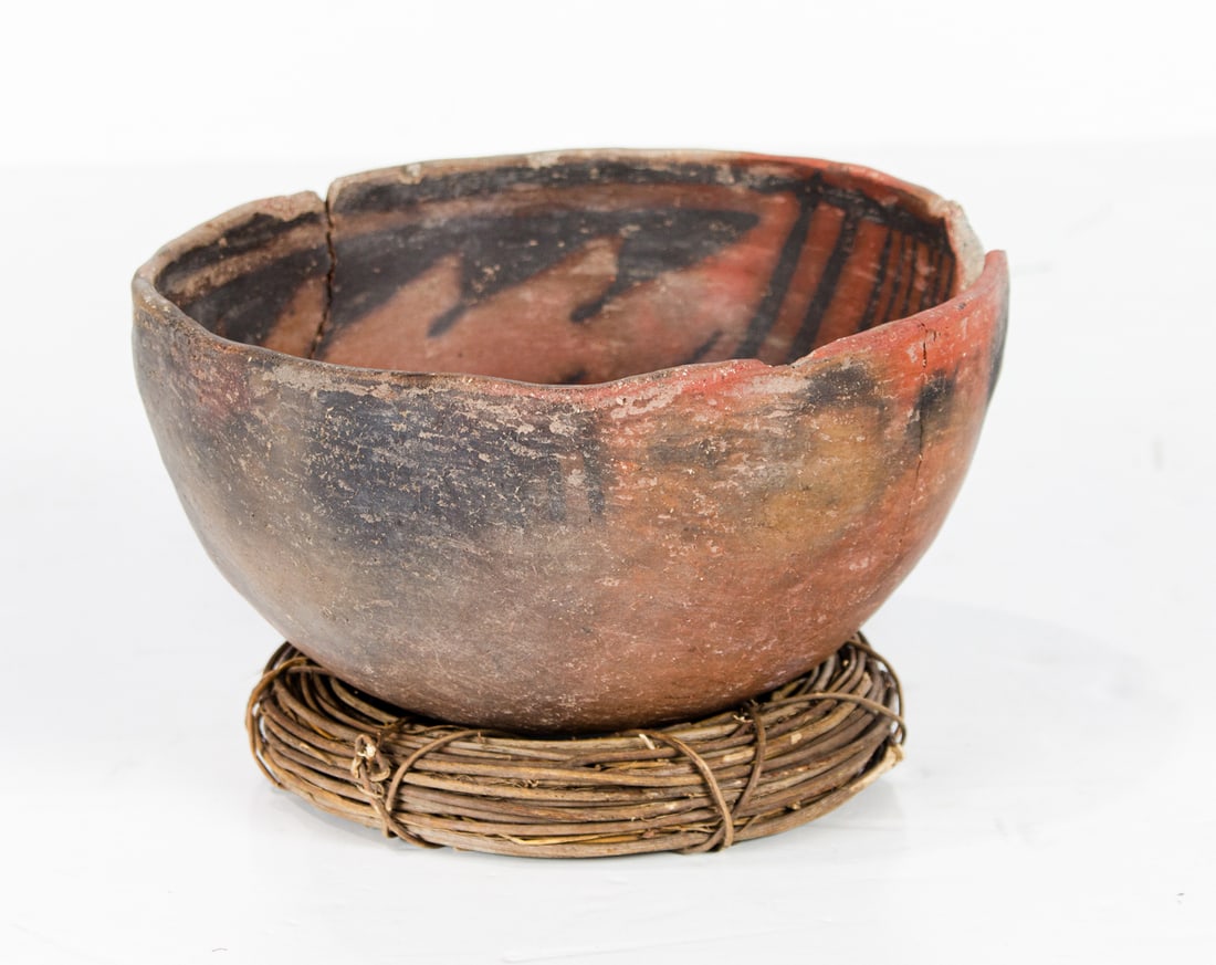 An ancestral Southwestern pottery bowl: An ancestral Southwestern pottery bowl, probably Anasazi, ochre pigment interior with black design, 4.5"h x 8"dia. Provenance: Tribes Gallery, Walnut Creek, with note inscribed 'Wingate Anazasi period