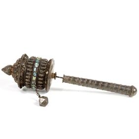 A Tibetan Buddhist gemstone inlaid silver prayer wheel