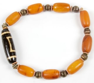 A group of Tibetan dzi and amber beads