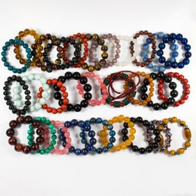 A group of stone and glass prayer beads