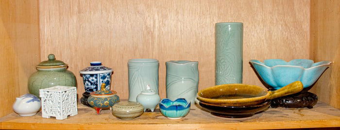 A shelf of Chinese and Japanese ceramic objects