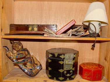 Two shelves of Asian decorative objects