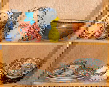 A shelf of Chinese Canton rose medallion articles