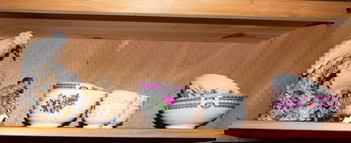 A shelf of Asian porcelain articles