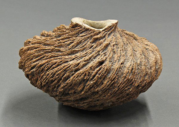 Anne Goldman stoneware low bowl: Anne Goldman stoneware low bowl, the carved and sculpted bulbous form with a textured 'Wind Drift' detail surrounding the body and rising on a circular base incised A.G, 5"h x 7"w