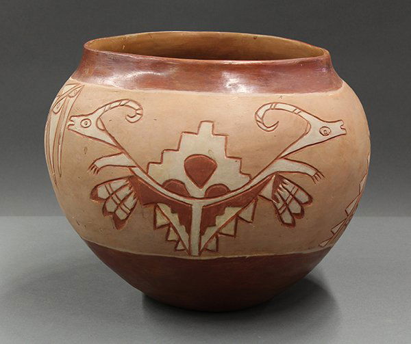San Juan redware olla: San Juan redware olla, circa 1935, the large form having an incised body centered with a double Avanyu figure flanked with stylized geometric sprays, 12"h x 12"w