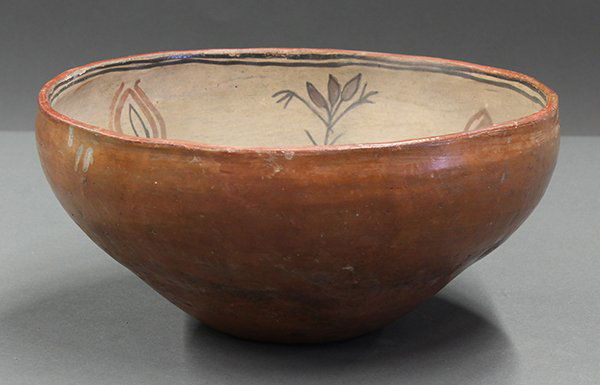 San Ildefonso interior painted bowl: San Ildefonso interior painted bowl, circa 1900, the polychrome decorated interior with floral sprays surrounding the geometric reserves, 5"h x 10.5"w